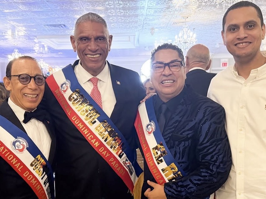 Gentlemen wearing custom National Dominican Day Parade sashes at a gala