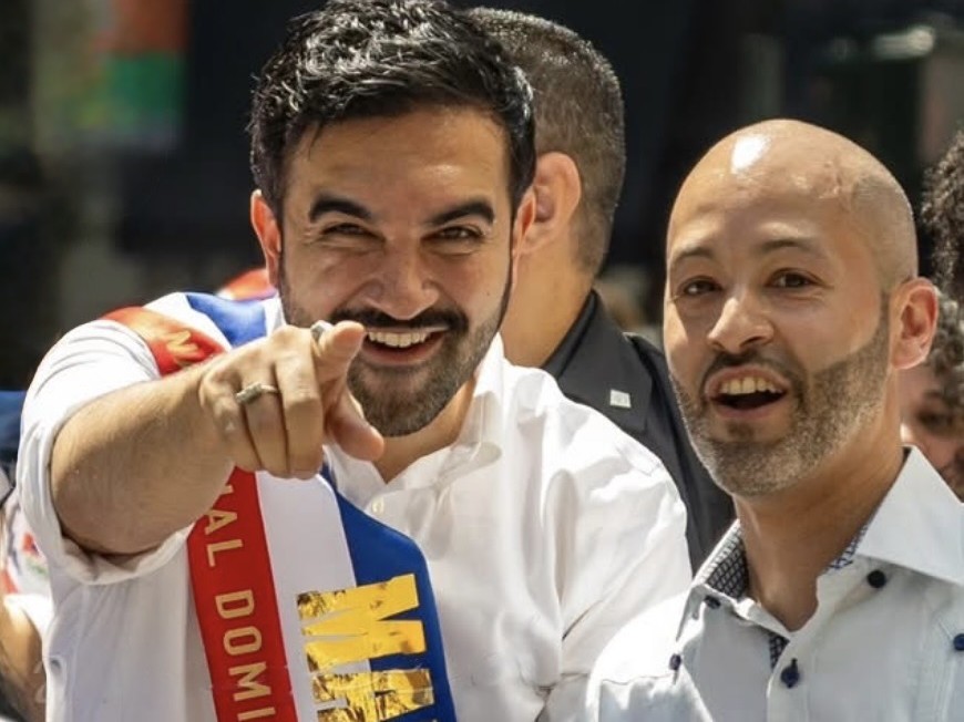 New York City mayor wearing a custom National Dominican Day Parade sash with a friend